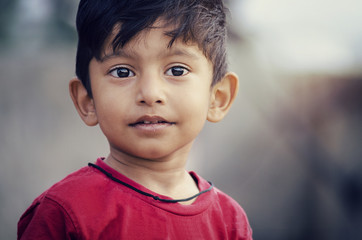 Sick poor boy child portrait looking sideways with soar lips