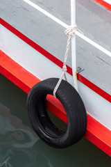 Fototapeta premium Tires used on pier or warf to protect commercial boats when tied