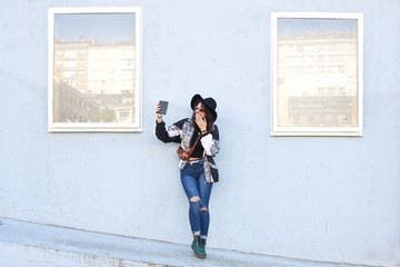 fashion girl with the tablet on the street