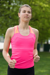 Fototapeta premium Young sporty woman running in park