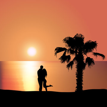 Loving couple on the seashore at sunset