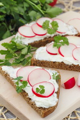 Sandwich with soft cheese, radish and parsley