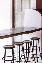 Bar with wooden vintage round tall chairs