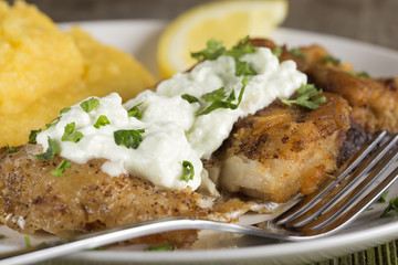 Fried carp with polenta and garlic sauce