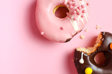 Donuts with icing on pink background. Sweet donuts. Donuts background . Eaten donut.