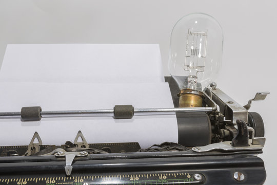 an antique typewriter with a light bulb