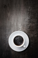 a cup of coffee on vintage wooden table