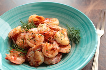 Shrimps with fresh dill served on a plate