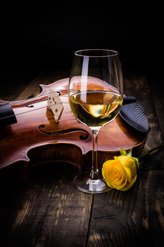 Violin, wine and yellow rose