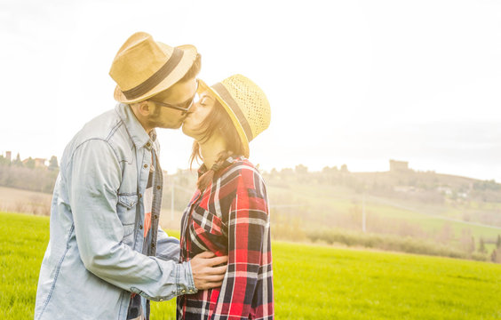closeup of a caucasian and loving couple while is kissing in a countryside - lifestyle, people and outdoor concept