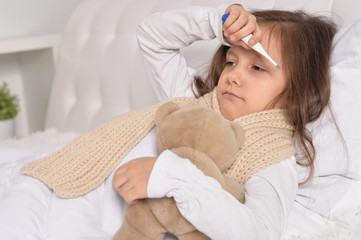 sick little girl lying in the bed