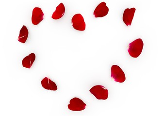 The red petals of the red rose lying on the floor in the shape of a heart