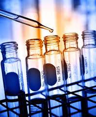 Dropping chemical to test tube 