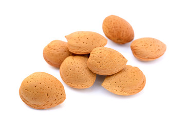 Pile of unpeeled almonds isolated on white background
