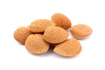 Pile of unpeeled almonds isolated on white background