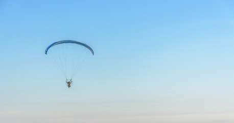 Paramotor on the sky in the evening:Close up,select focus with s