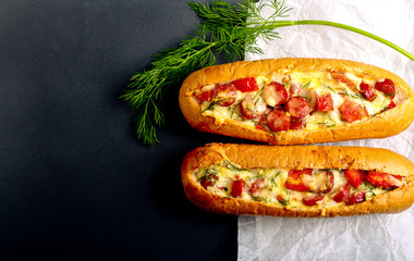 Sausage, tomato and cheese bread boats