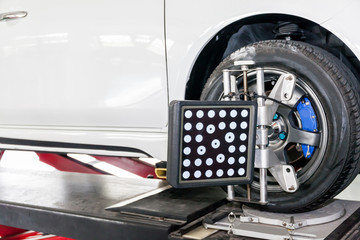 Suspension adjustment and Automobile wheel alignment work being installed with computerized...