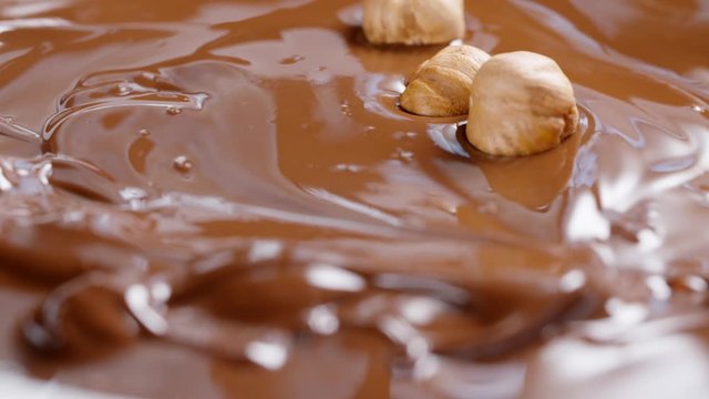 hazelnuts falling in melted chocolate, 180fps footage
