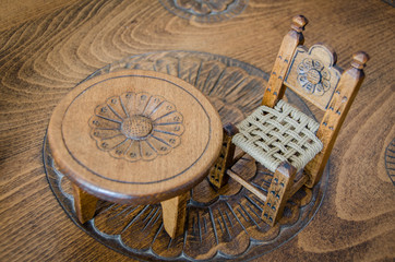 Fine art .Miniature wooden hand made chair and table on carved table