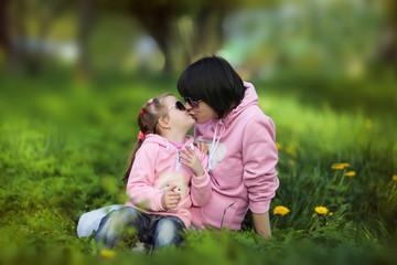 Mother and daughter kissing