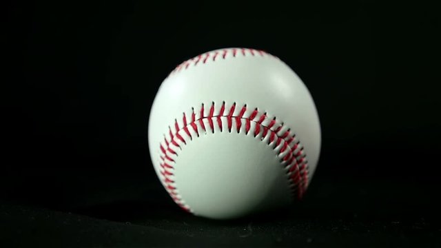 Baseball ball on a black background, slow motion