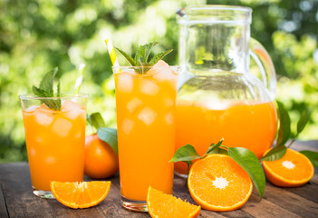Fototapeta na wymiar Orange juice in the glass with ice