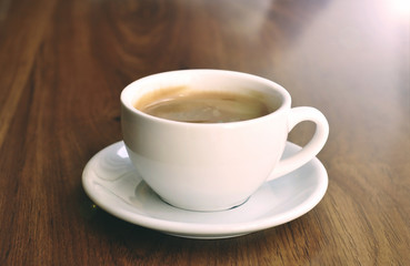 White cup on the wooden table 