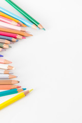 Closeup of Colour pencils on white background, selective focus