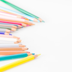 Closeup of Colour pencils on white background, selective focus