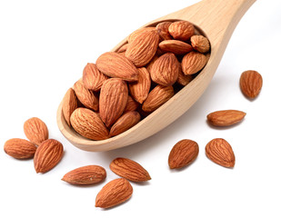 dried almonds in wooden spoon