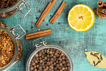 Spices and herbs in jars. Food, cuisine ingredients. Wooden board.