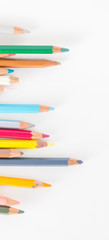 Closeup of Colour pencils on white background, selective focus
