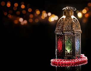 Vintage lantern with red rosary..