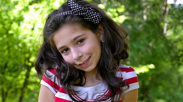 Slow motion portrait of a cute young girl smiling