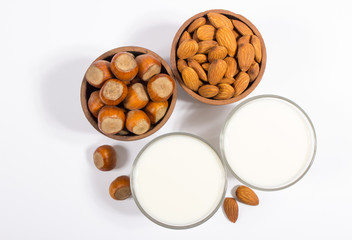 Glass of hazelnut milk and almond isolated on white background.