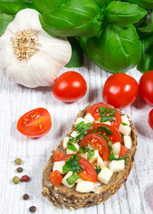 Ciabatta bread with tomatoes, mozzarella and basil.