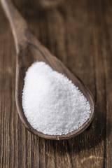 White Sugar (selective focus) on wooden background