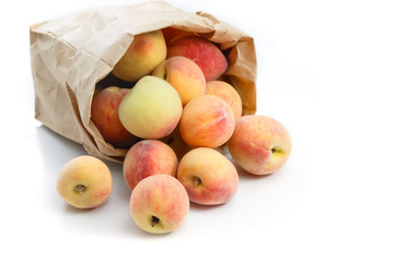 French peaches in paper bag isolated on white