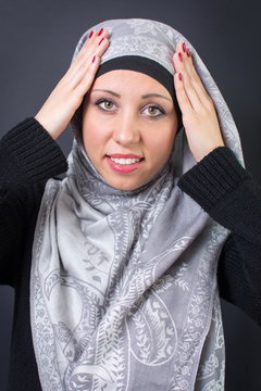 Muslim woman adjusting her headscarf