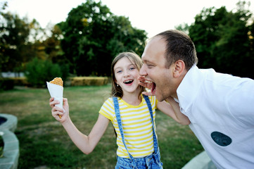 Fototapeta premium Kid girl don't want to share ice cream