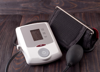 automatic blood pressure monitor on a wooden background