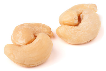 few cashew nuts on a white background close-up