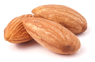 Three almonds isolated on white background macro