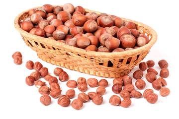 hazelnuts in a wicker basket isolated on white background