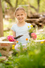 Cute Little Girl Planting Flowers