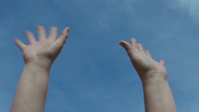 Hands against the sky.