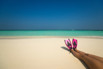 Woman relaxing on summer beach vacation holidays lying in sand.