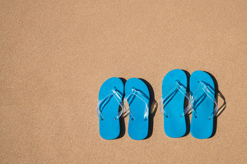 Fototapeta na wymiar flip flops on a sand