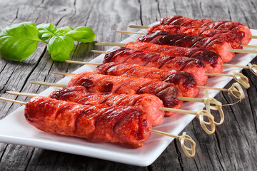 Grilled sausages on a white dish, close-up